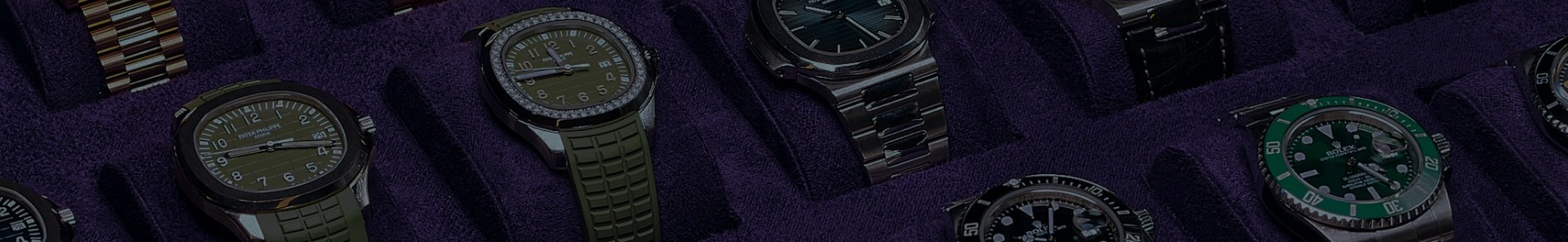 Curated collection of luxury watches including Rolex, Patek Philippe, and Audemars Piguet displayed in a velvet case